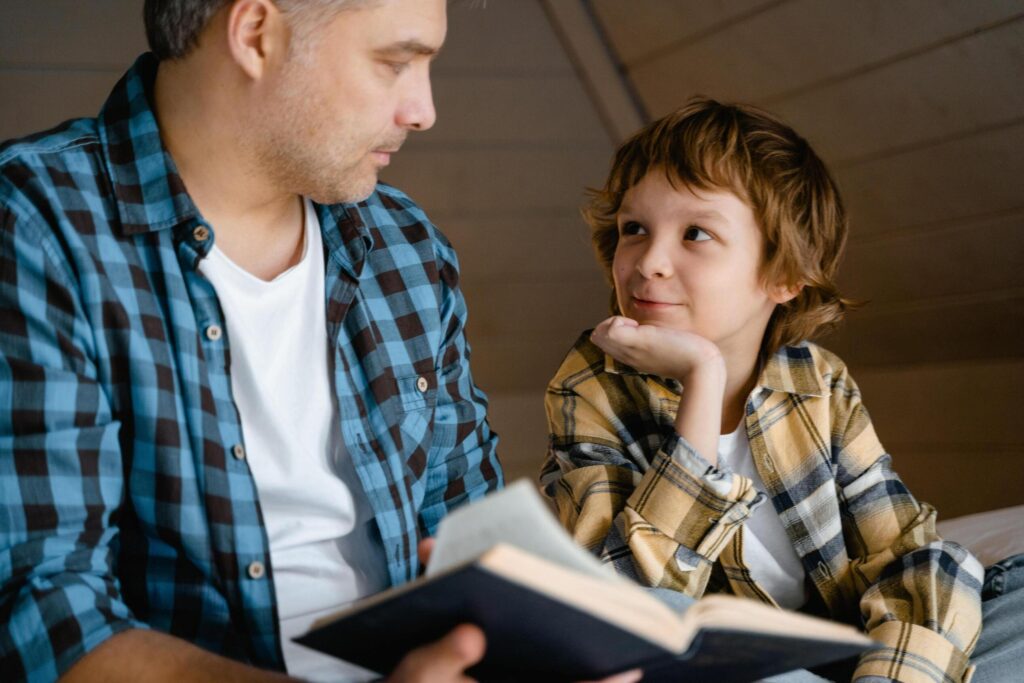 Dad Reading Story To Son